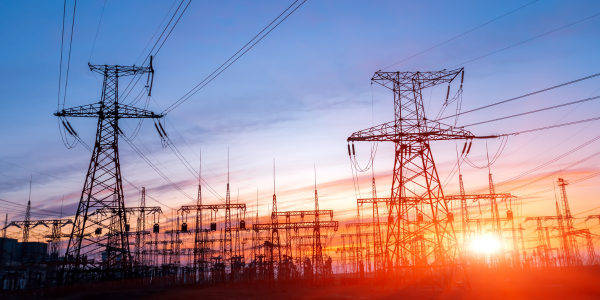 Power lines in front of sunset